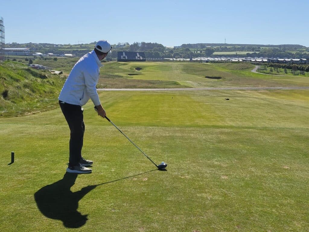 A golfer tees off on an Irish links course on a Lyons Links golf tour
